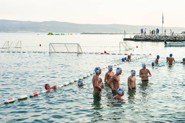 Water polo players in Omis Croatia Omis, Croatia - August 17, 2016: Water polo players in Omis, Dalmatia, Croatia water polo cap stock pictures, royalty-free photos & images