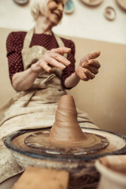 istock Front view of female craftsman working on potters wheel 685010696