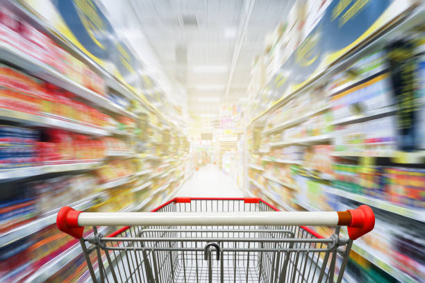 istock Supermarket aisle with empty red shopping cart 685014912