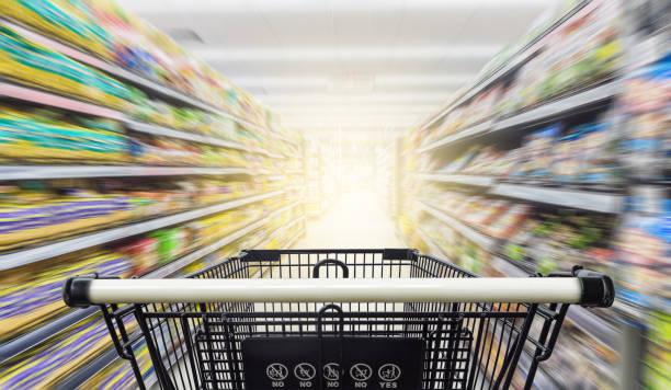 istock Supermarket aisle with empty shopping cart 685014918
