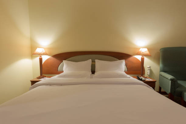 istock Double bed in bedroom with lamp turn on 685021370