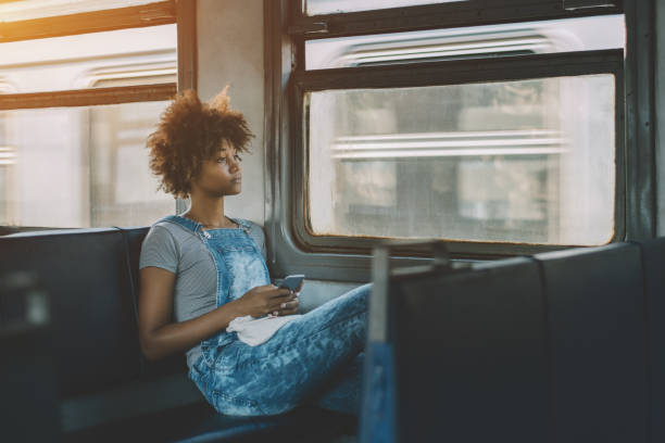 istock Thoughtful curly black girl in train with smartphone 685046556