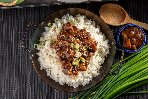 Steamed rice topped with black bean sauce and pork