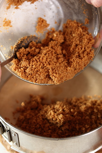 Transfer cookies mixture into baking pan. Making frozen strawberry cheesecake series.