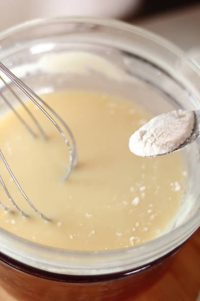 istock Adding and mixing powdered sugar and melted white chocolate. Making frozen strawberry cheesecake series. 685091816