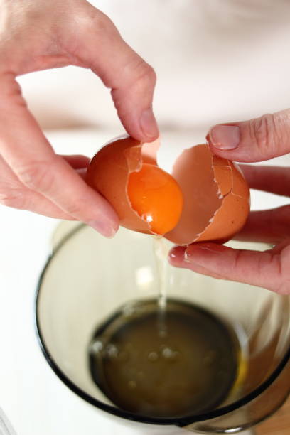 istock Separating Egg Whites and Egg Yolks. Making frozen strawberry cheesecake series. 685091962