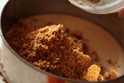 Transfer cookies mixture into baking pan. Making frozen strawberry cheesecake series.