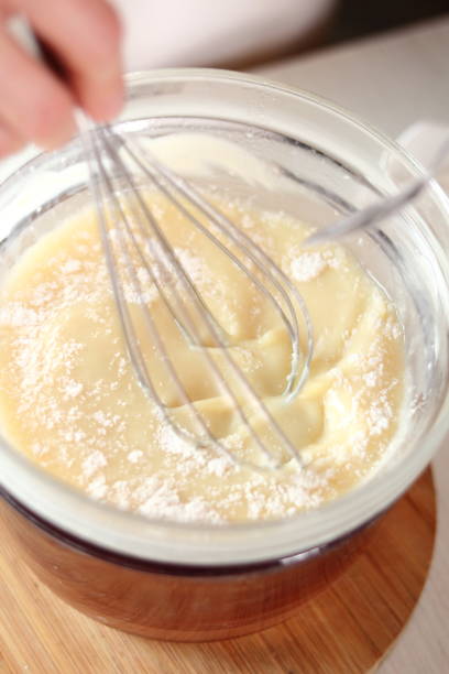 istock Adding and mixing powdered sugar and melted white chocolate. Making frozen strawberry cheesecake series. 685094354