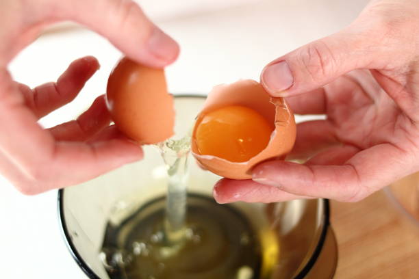istock Separating Egg Whites and Egg Yolks. Making frozen strawberry cheesecake series. 685094564