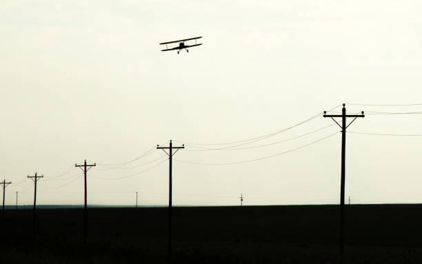 Biplane and poles in silhouette