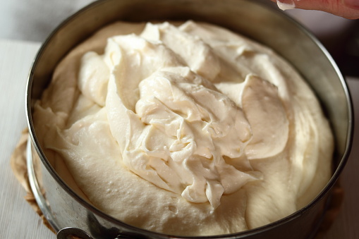 Transfer cheese filling into baking pan. Making frozen strawberry cheesecake series.