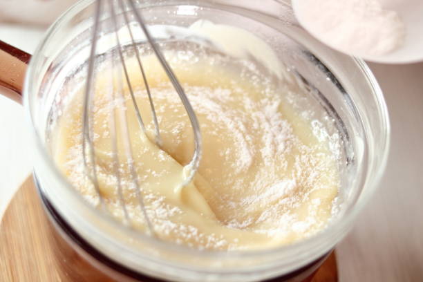 istock Adding and mixing powdered sugar and melted white chocolate. Making frozen strawberry cheesecake series. 685114690