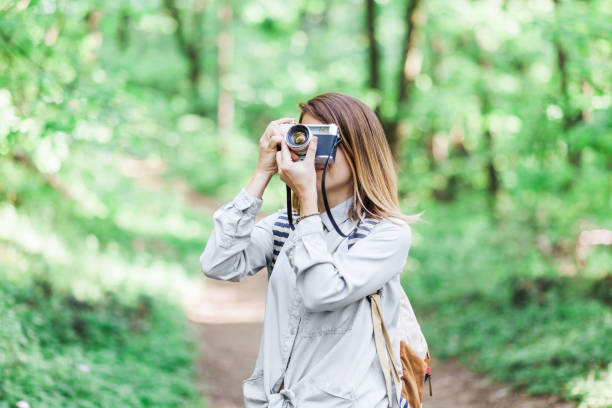 istock Young woman taking a photograph 685117828
