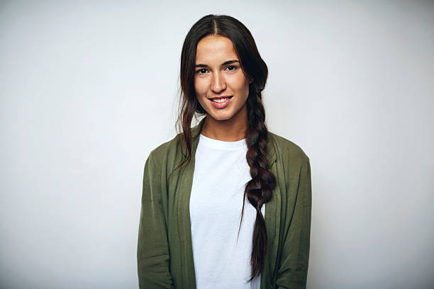 Businesswoman with braided hair over white Portrait of businesswoman with braided hair. Confident female professional is wearing jacket. She is smiling over white background. looking at camera stock pictures, royalty-free photos & images