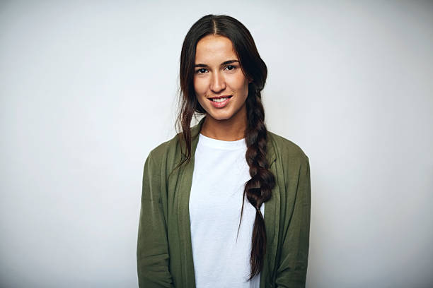 Businesswoman with braided hair over white Portrait of businesswoman with braided hair. Confident female professional is wearing jacket. She is smiling over white background. one young woman only stock pictures, royalty-free photos & images