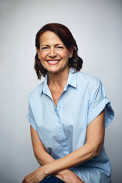 businesswoman smiling over white background - blue vertical color image photography imagens e fotografias de stock