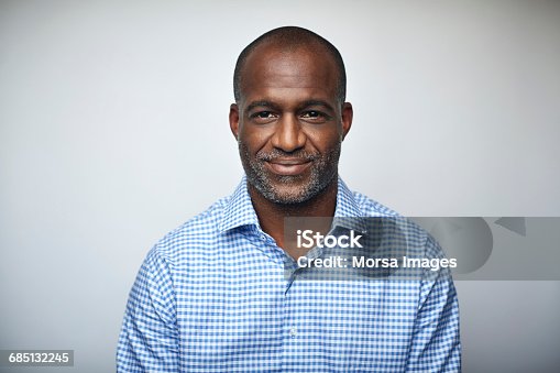 istock Mature businessman smiling over white background 685132245