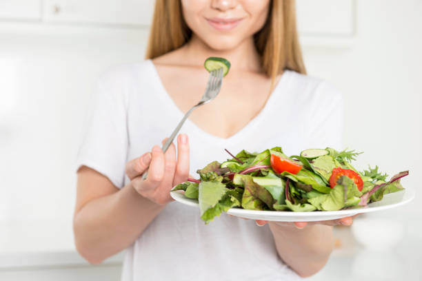 istock Woman dieting and eating a salad 685147288