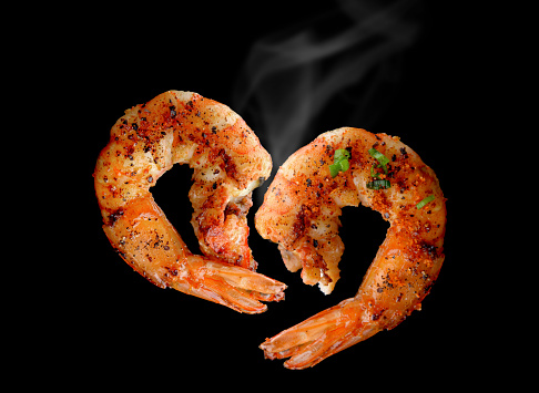 Grill Shrimp BBQ style mixed spicy ,ingredient set in black backgrount with smoke in studio lighting.