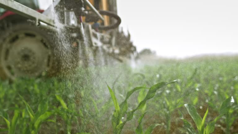 SLO MO Nozzles on the boom sprayer spraying liquid on the corn crops