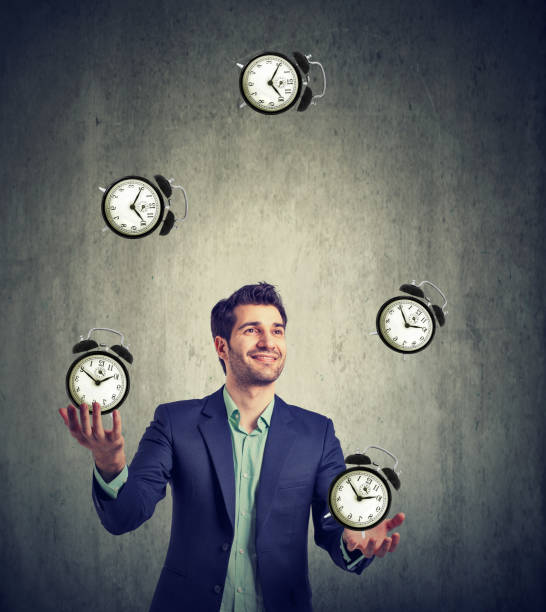 istock business man juggling his time alarm clocks 685165742