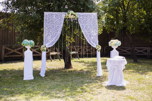 istock Beautiful wedding ceremony outdoors. White wedding arch on the natural background. 685165986