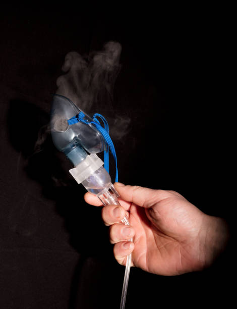 istock Man holding nebulizer mask with vapour 685188572