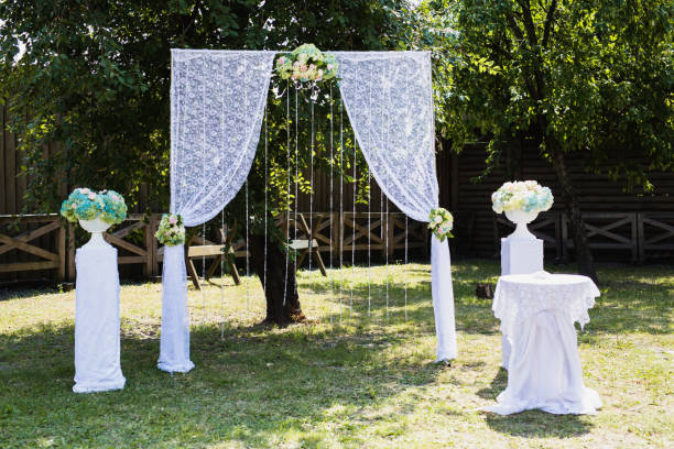 istock Beautiful wedding ceremony outdoors. White wedding arch on the natural background. 685209746