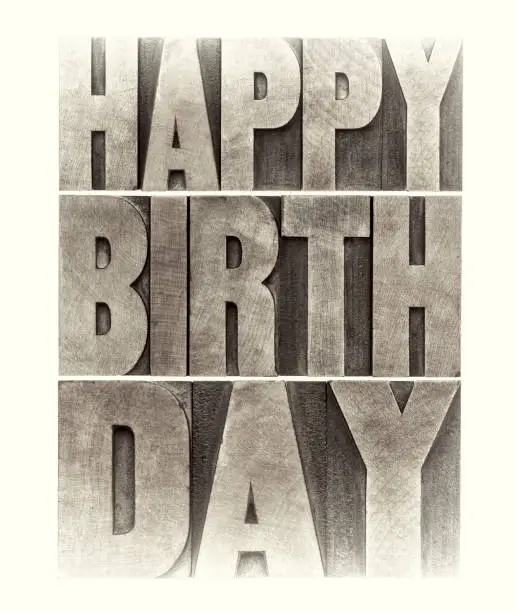 happy birthday greeting card - word abstract in letterpress wood type printing blocks, sepia toned image