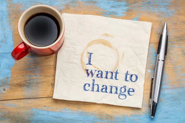 I want to change declaration - handwriting on a napkin with a cup of coffee