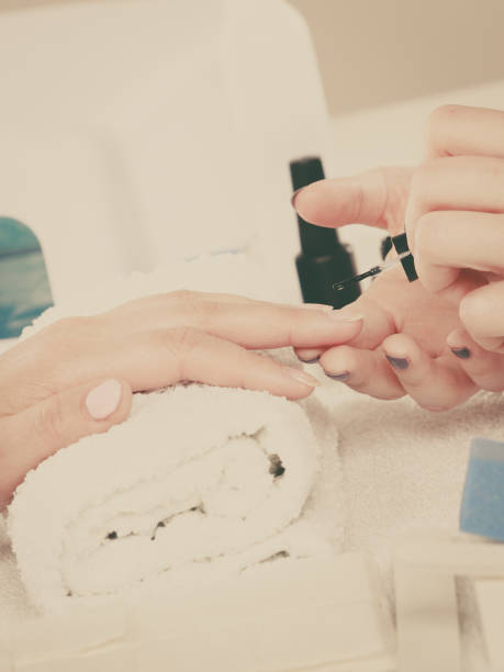 istock Woman in beauty salon getting manicure done. 685220586