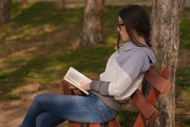 istock Young girl reading a book 685221194