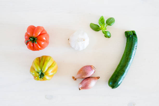 istock Colorful vegetables on a table. Tomatoes, basil, shallots, onions, zucchini and garlic. 685238858