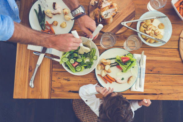 istock Father serving food to his son. 685238966
