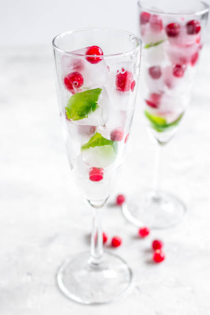 istock fresh cranberry in ice cubes in glasses on white background mock-up 685244280