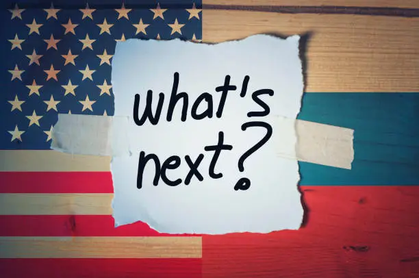 What's Next? on torn paper with Russian and American flag