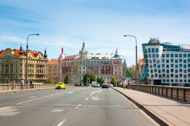 Prague, Czech Republic  - 8 August, 2016: View to The Dancing House from bridge over Vltava river, Prague, Czech Republic,  8 August, 2016 Prague, Czech Republic  - 8 August, 2016: View to The Dancing House from bridge over Vltava river, Prague, Czech Republic,  8 August, 2016 dancing house prague stock pictures, royalty-free photos & images