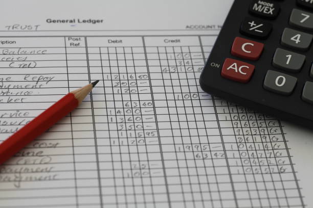 Accounting Ledger Handwritten Accounting ledger showing bookkeeping using pencil and calculator. general military rank stock pictures, royalty-free photos & images