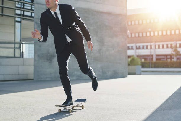 istock Stylish manager riding a skateboard in city 685401802