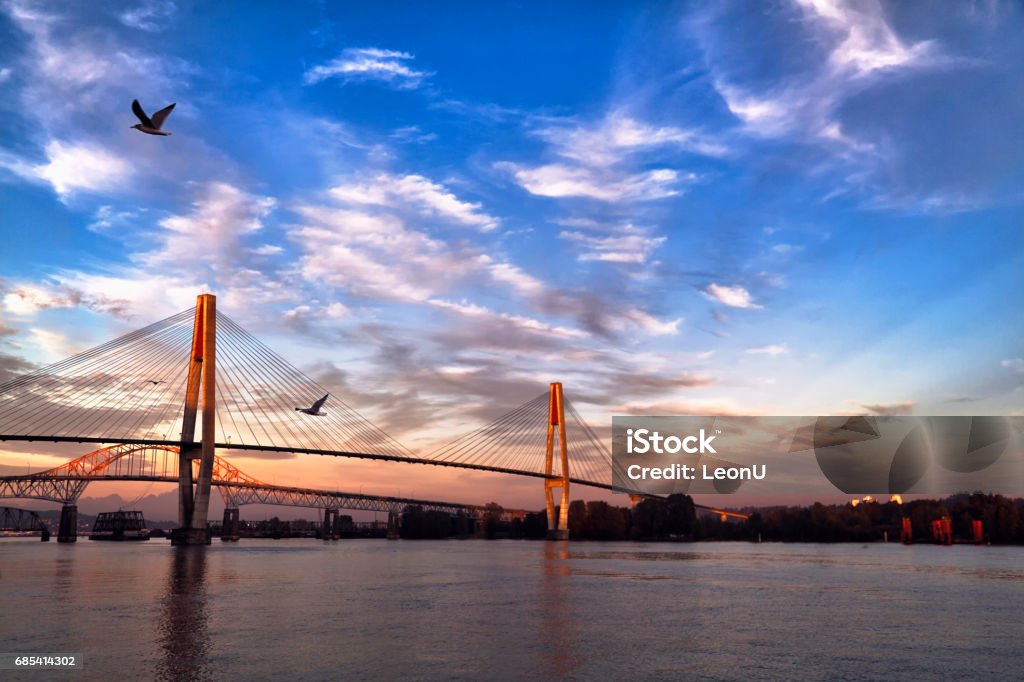 Fraser river at sunset, BC, Canada Fraser river at New Westminster, skytrain bridge and pattullo bridge in the picture. British Columbia Stock Photo