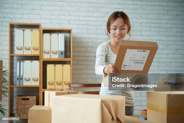 Opening Parcel Stock Photo - Download Image Now - Ordering, Shipping, Asian and Indian Ethnicities