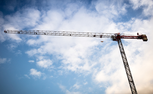 A crane at a construction site of a new apartment building during the early morning in Seattle, WA.
