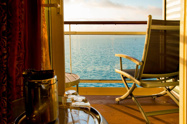 Calm scene of a deck chair at dusk viewing a beautiful sunset from a cruise ship