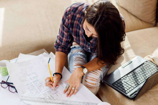 Young female student working at home.