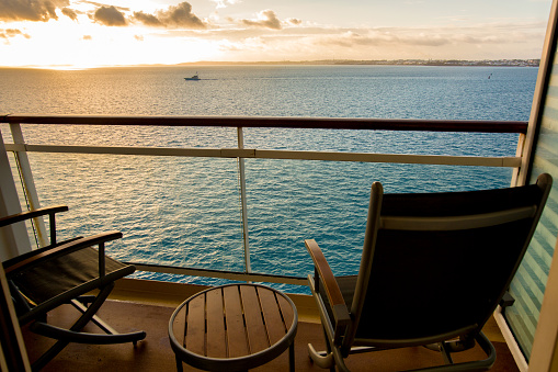 Empty Deck Chair on a Cruise Ship Balcony at Dusk