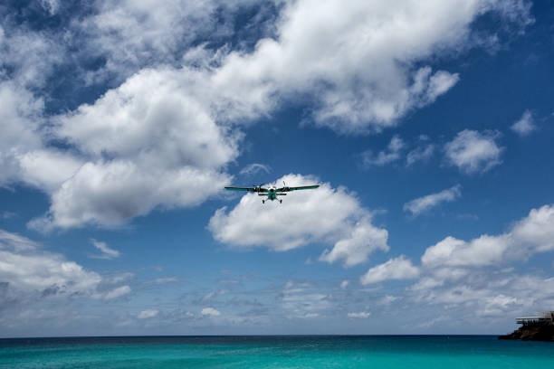 istock Small Commercial Plane Landing Over Beach 685427668