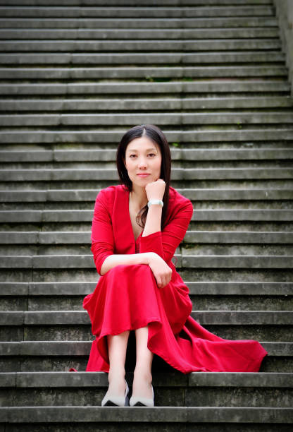 istock Long hair beautiful woman sitting on the steps 685430356
