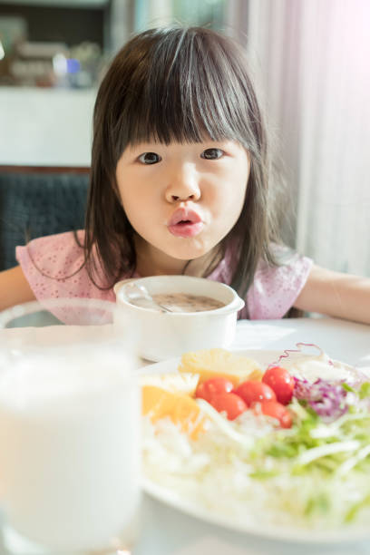 istock cute girl eat breakfast 685433034