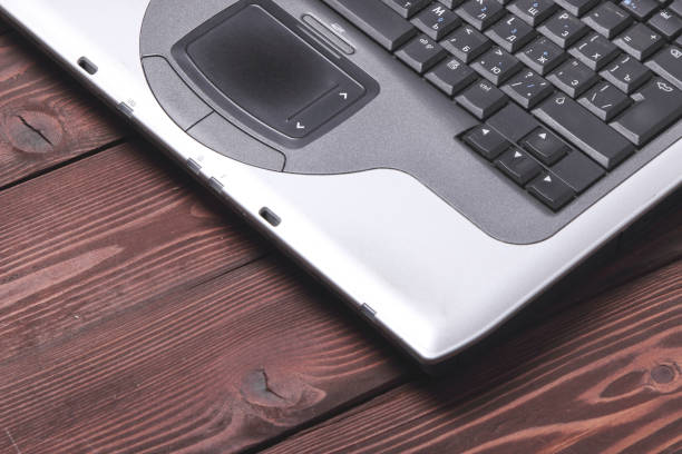 istock laptop on dark wooden background 685438390