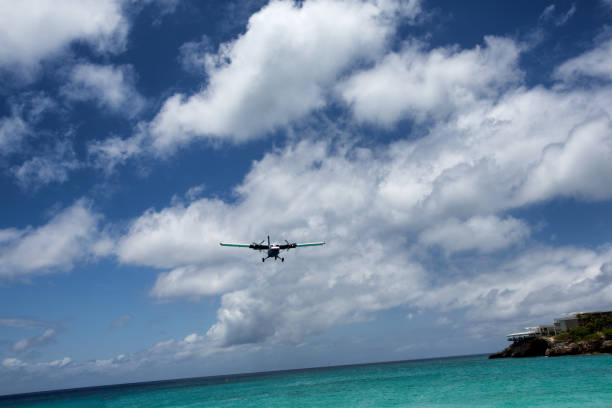 istock Small Commercial Plane Landing Over Beach 685438562